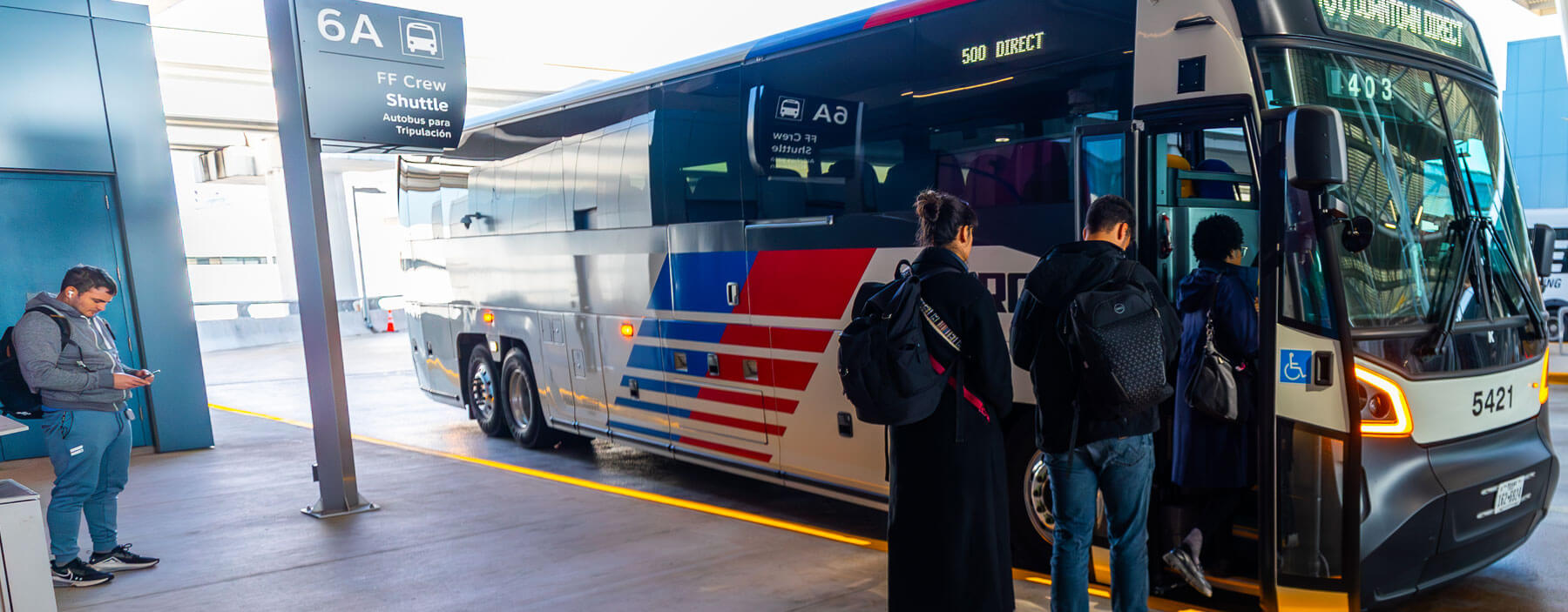 Customers boarding the 500 Downtown Direct bus at IAH Airport.